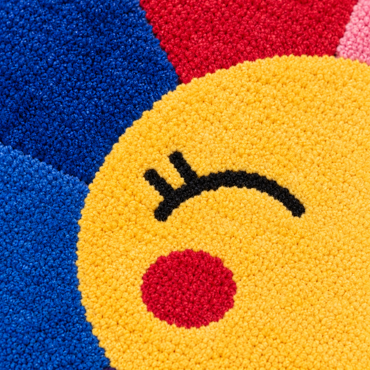 Vif – détail du visage souriant brodé